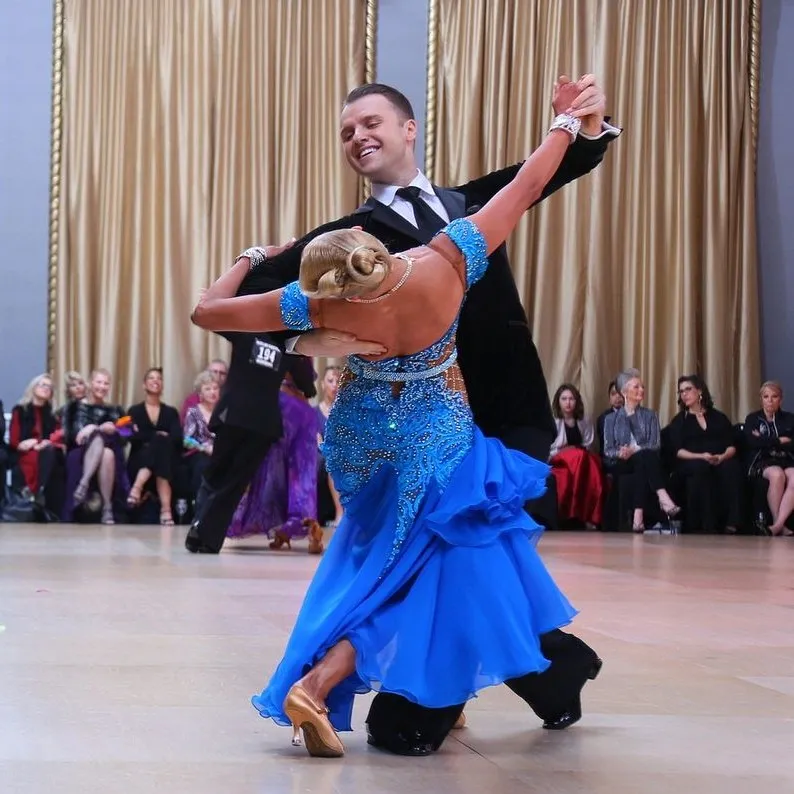 Slawek and Denise mid-turn in a ballroom standard dance at a competition